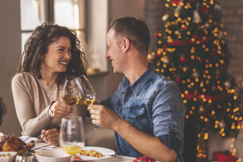 Couple making a toast at Christmas family dinner