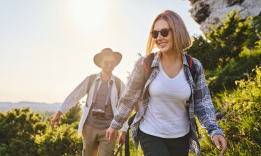 Happy couple hiking together in the mountains