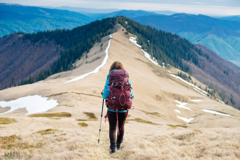 Girl,Tourist,With,Backpack,Is,Traveling,Mountains